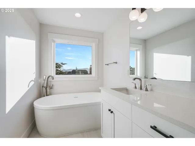 a bathroom with a sink a large mirror and a bathtub