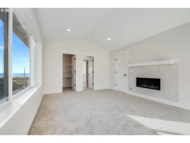 a view of empty room with a fireplace