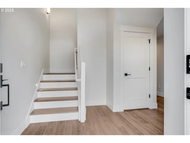 a view of an entryway with wooden floor