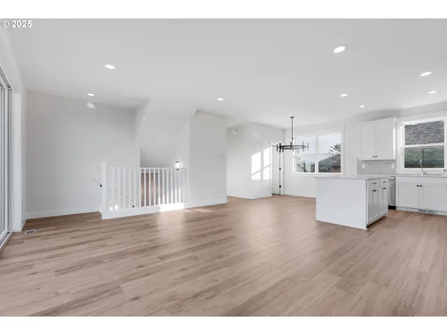 a view of a kitchen with a sink wooden floor and a window