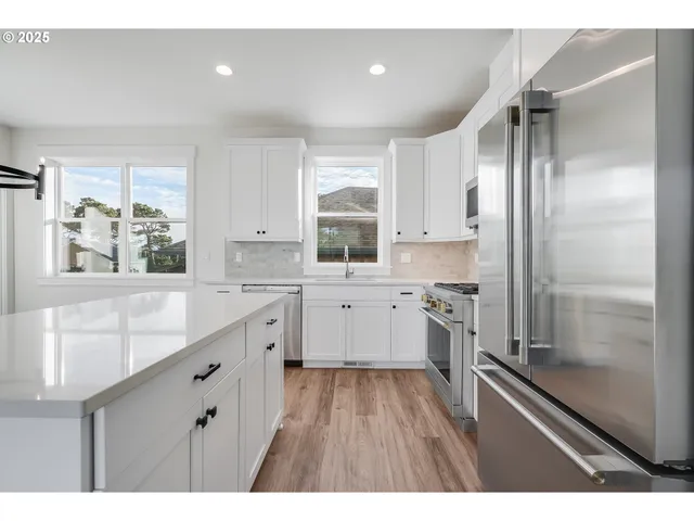a kitchen with a refrigerator sink and stove