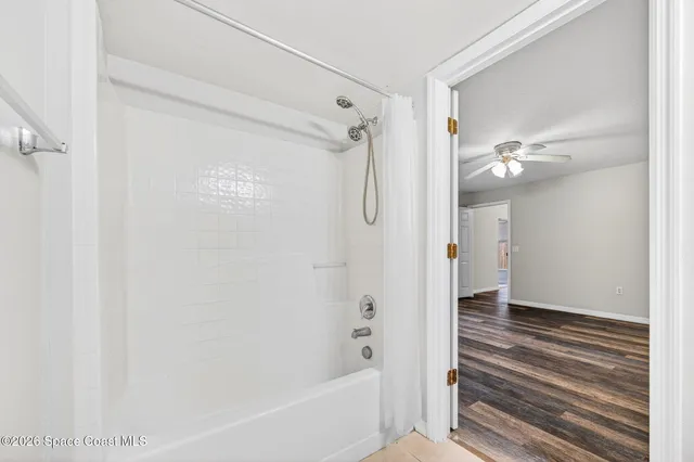 a bathroom with a granite countertop sink toilet and a mirror