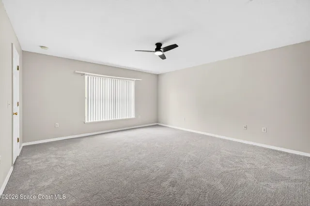 a view of a livingroom with a furniture a ceiling fan and wooden floor