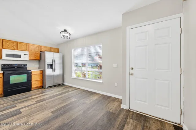 a view of kitchen with furniture and refrigerator