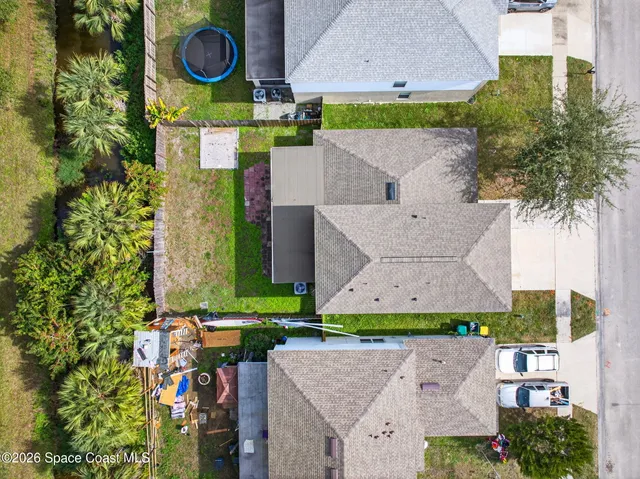 a view of an empty room with wooden floor and a porch