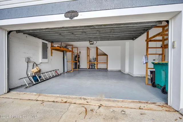 a view of a backyard with a fence and plants