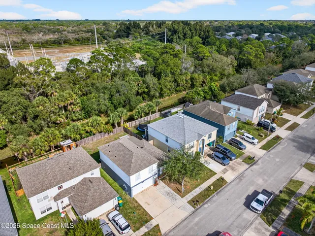 an aerial view of residential house with outdoor space and swimming pool