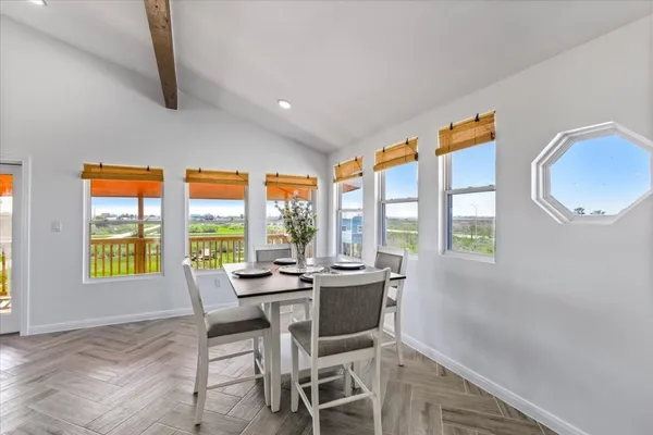 a view of a dining room with furniture window and outside view