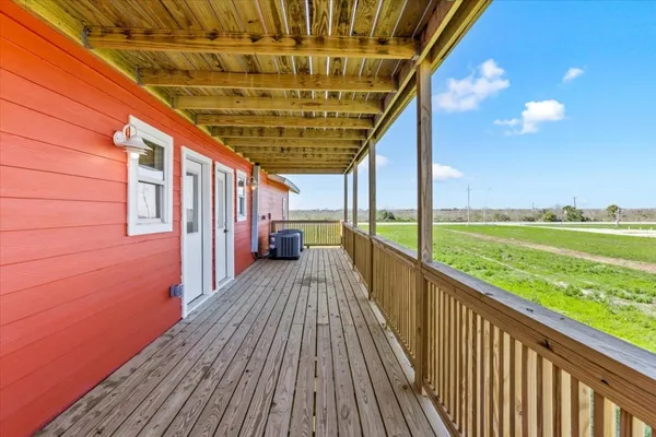 a view of a balcony with wooden floor