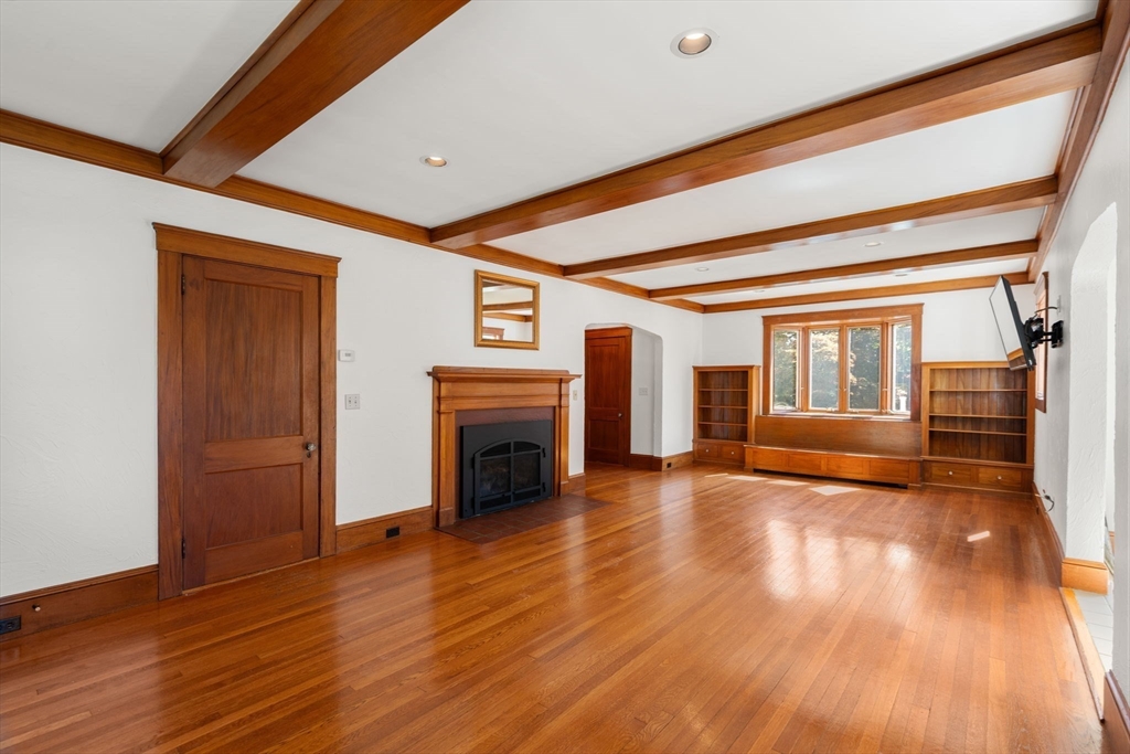 43 Laconia Road Worcester, MA 01609 - Photo 7 of 37 a view of empty room with wooden floor and fireplace