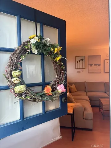a living room with furniture flowerpot and wooden floor