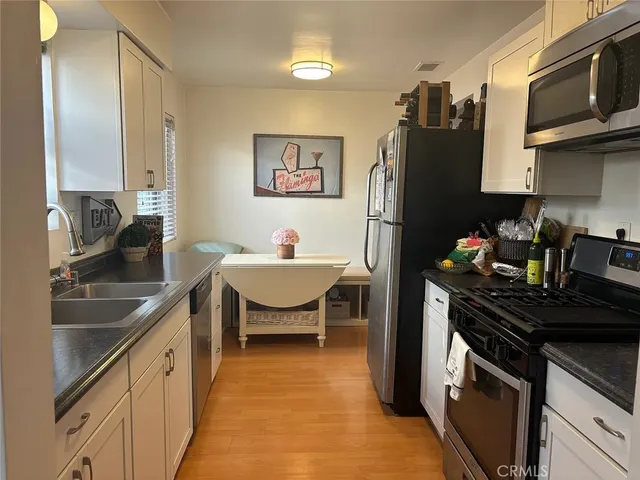 a kitchen with a sink appliances and cabinets