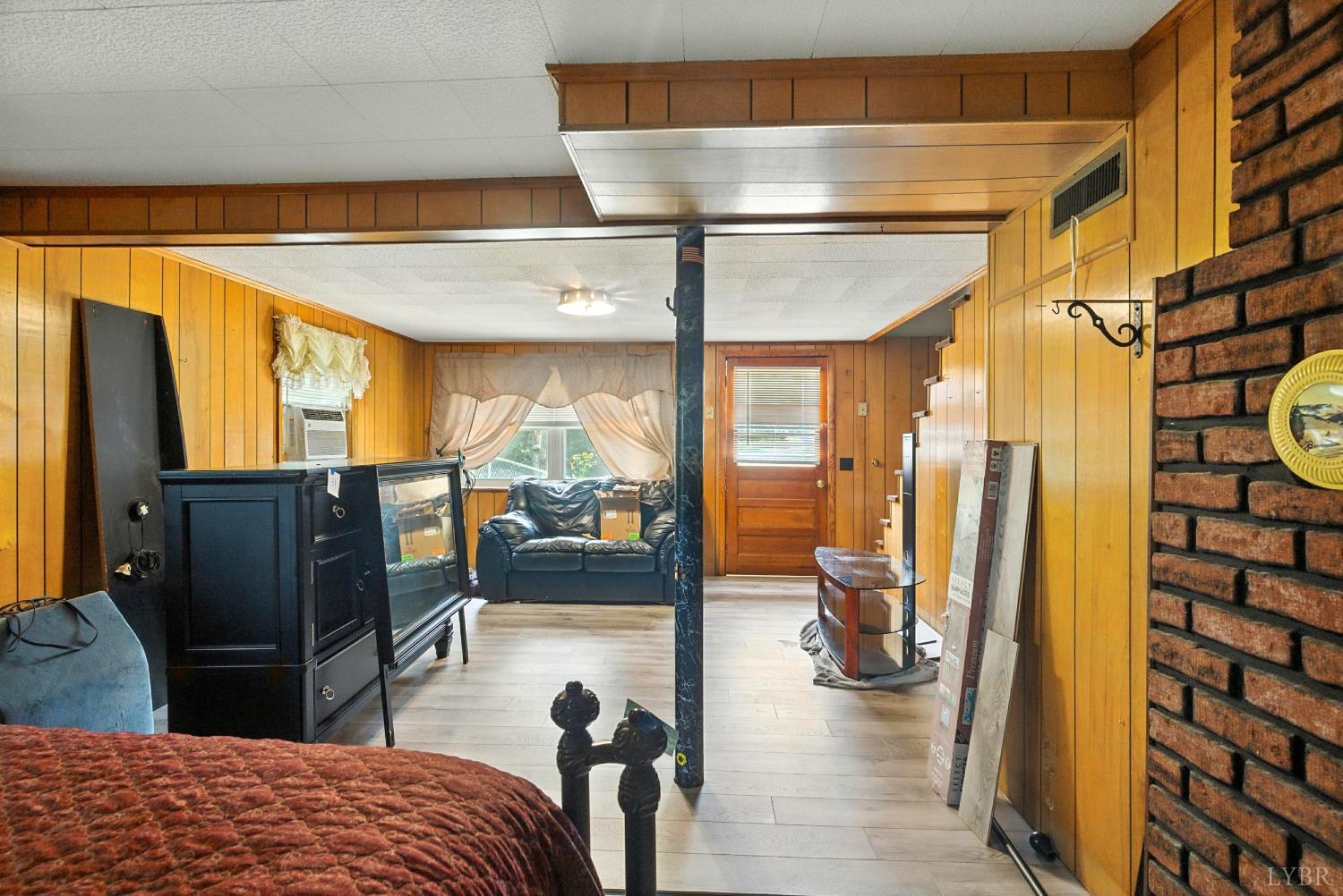 112 Hillside Road Hurt, VA 24563 - Photo 23 of 39 a bedroom with a bed and wooden floor