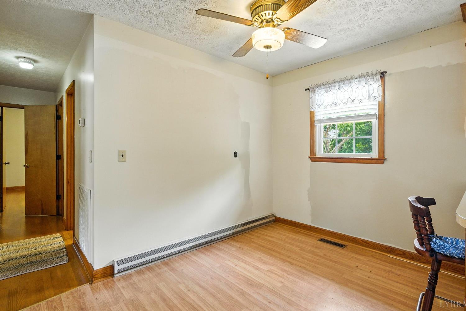112 Hillside Road Hurt, VA 24563 - Photo 7 of 39 a view of an empty room with wooden floor and a window