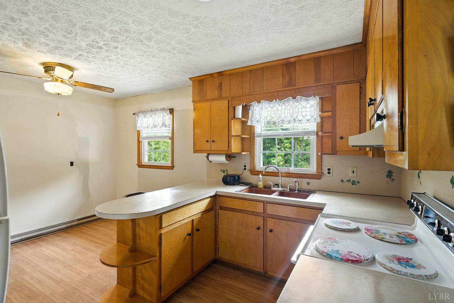 112 Hillside Road Hurt, VA 24563 - Photo 10 of 39 a kitchen with a sink window and cabinets