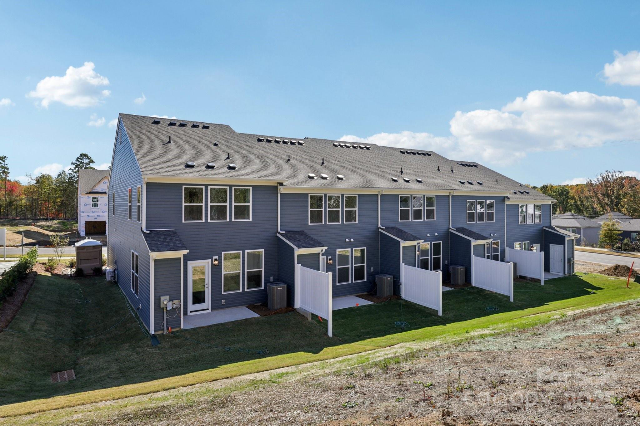 7717 Ethora Way Charlotte, NC 28216 - Photo 14 of 24 a front view of a house with a yard