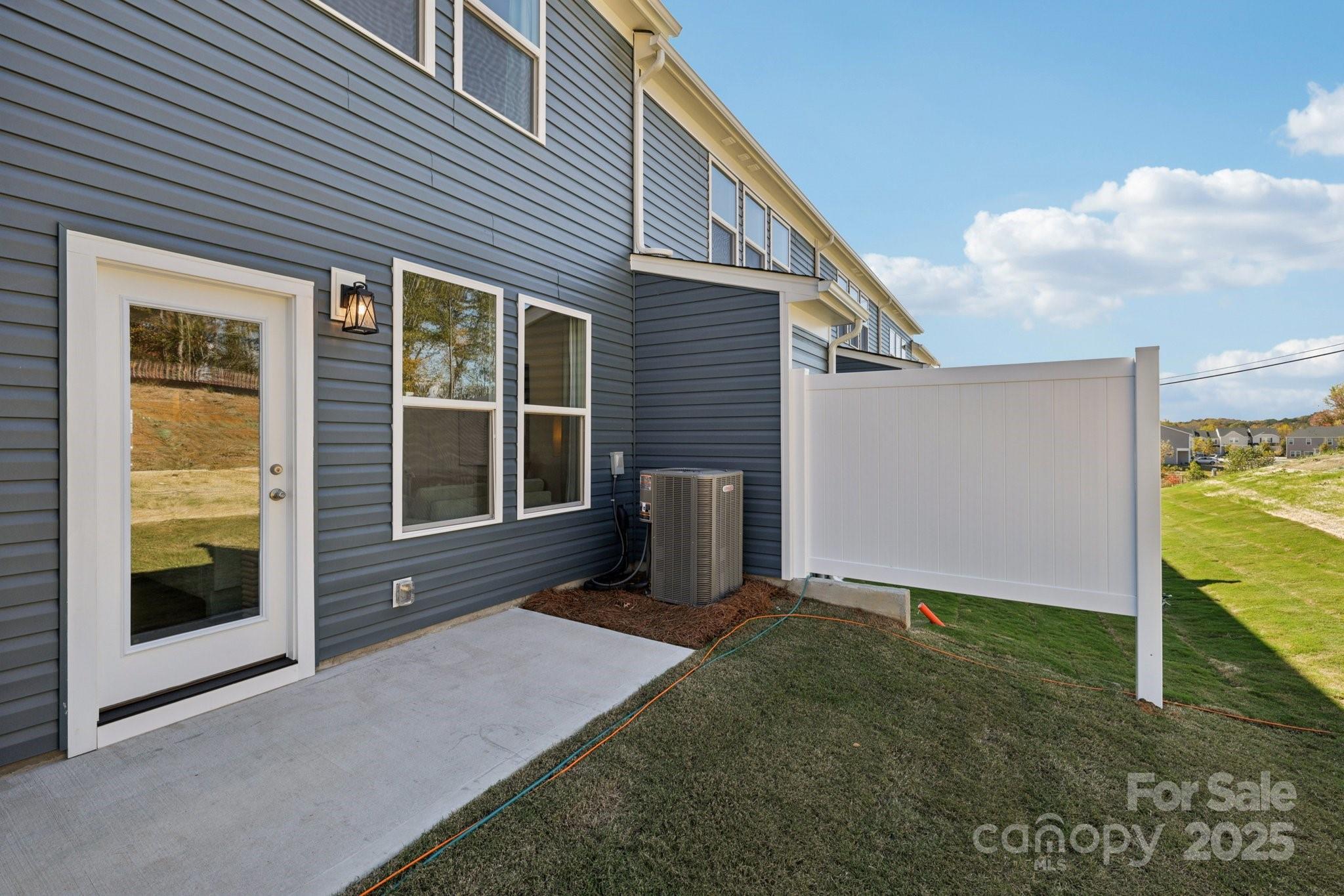 7717 Ethora Way Charlotte, NC 28216 - Photo 15 of 24 a view of backyard with large tree