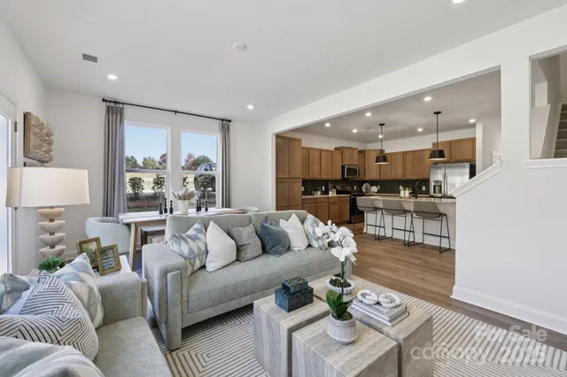 a living room with furniture and kitchen view