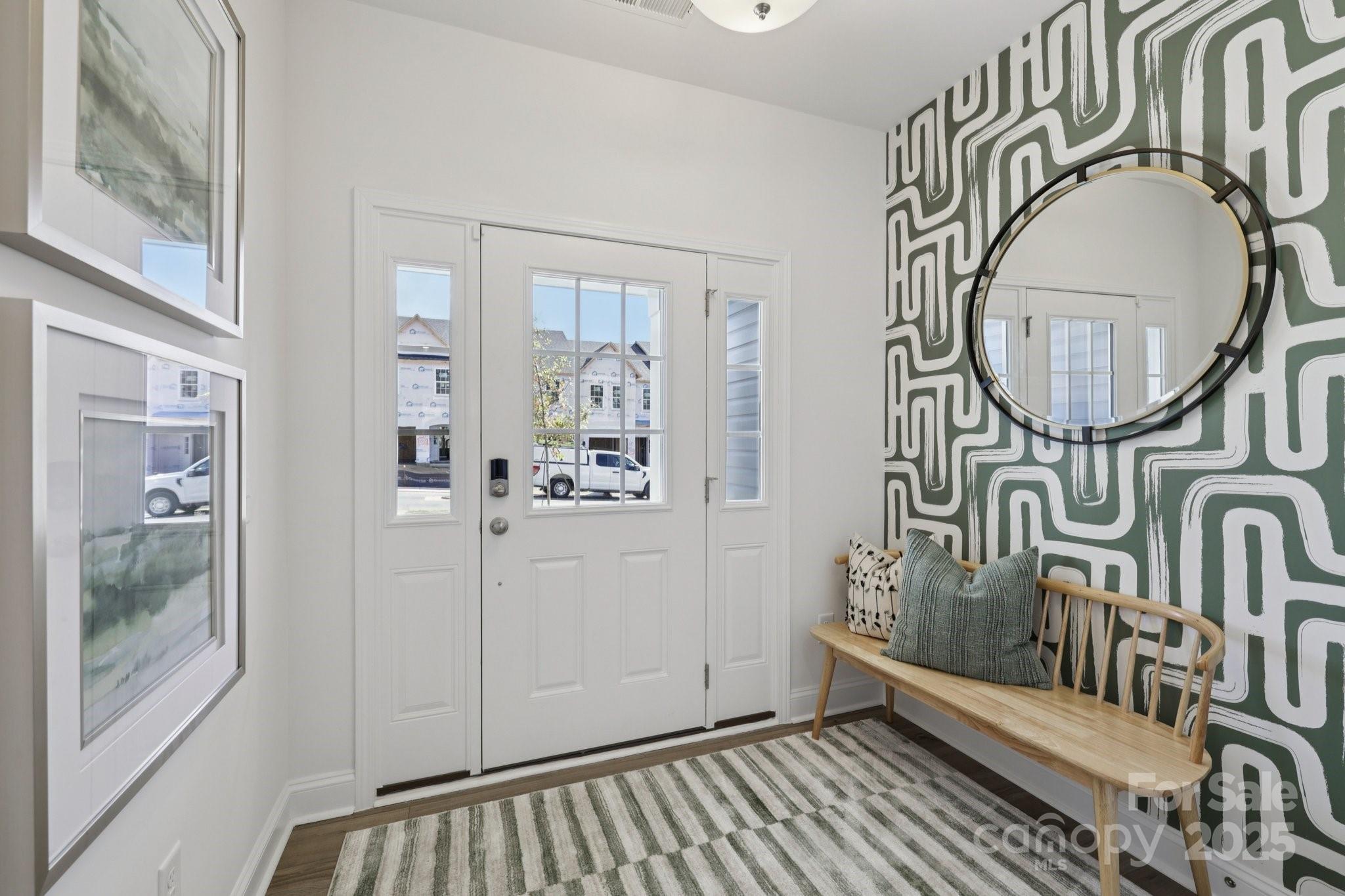 7717 Ethora Way Charlotte, NC 28216 - Photo 5 of 24 a view of an entryway with wooden floor