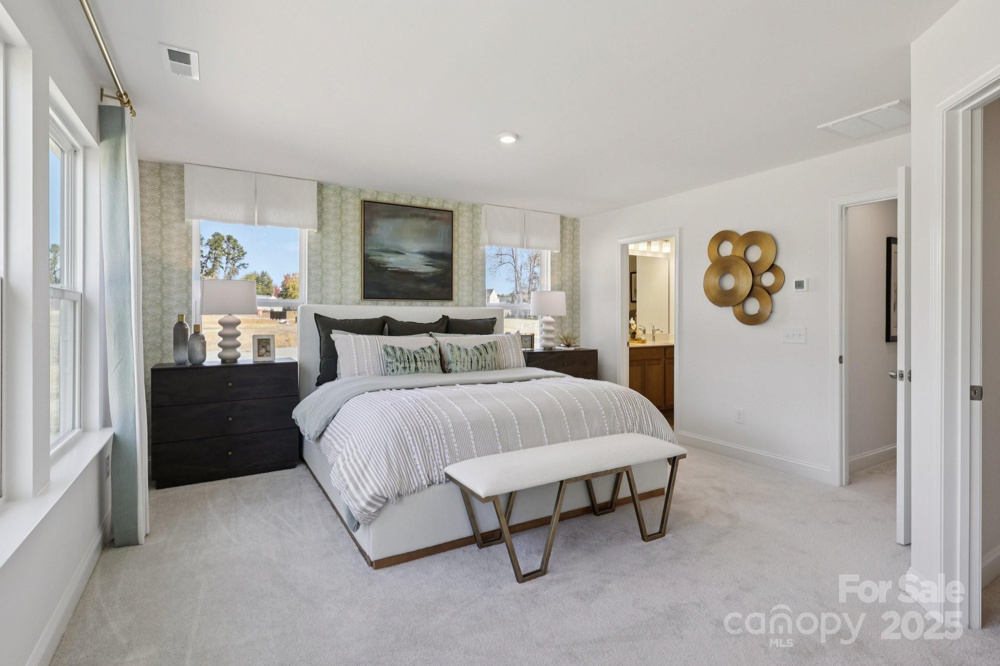 7717 Ethora Way Charlotte, NC 28216 - Photo 9 of 24 a bedroom with a bed and a table