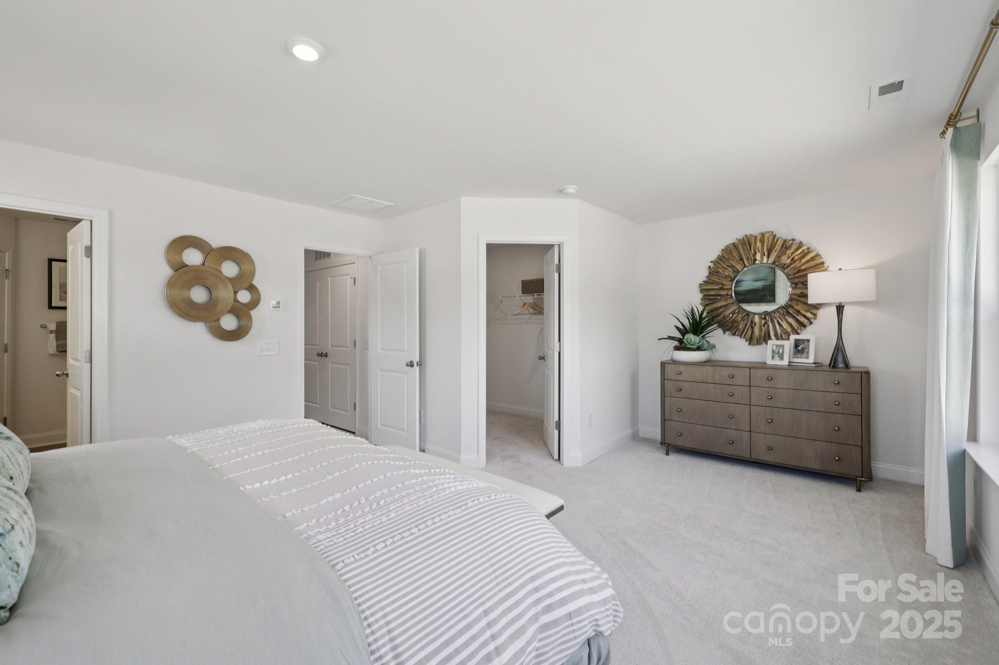 7717 Ethora Way Charlotte, NC 28216 - Photo 10 of 24 a bedroom with a bed and a dresser