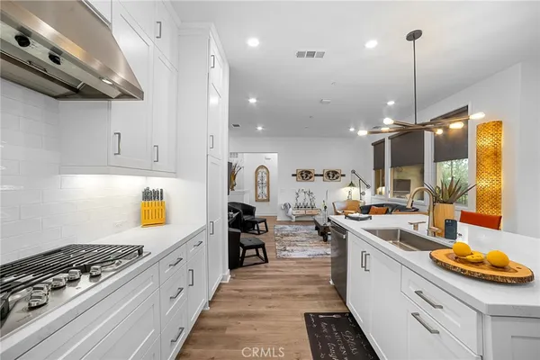 a kitchen with stove and cabinets
