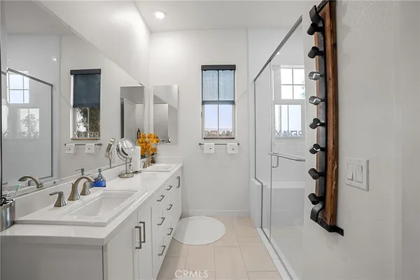 a bathroom with a double vanity sink toilet and shower