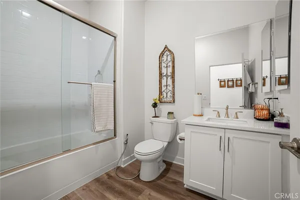 a bathroom with a sink a toilet and a large mirror