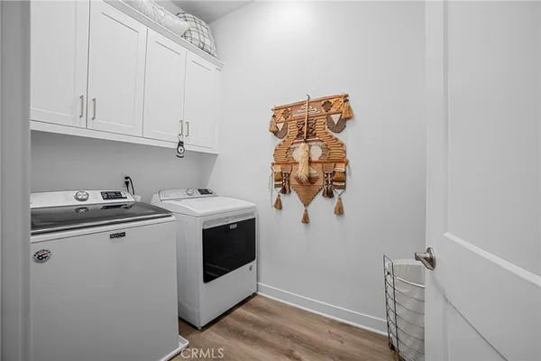 a view of a storage and utility room with washer and dryer