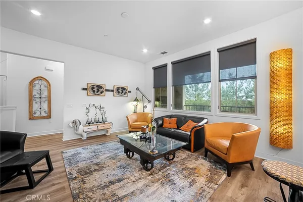 a living room with furniture a rug and a large window