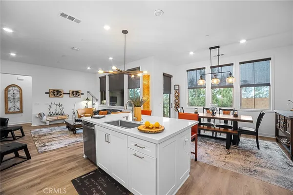 a kitchen that has a lot of cabinets a sink and appliances in it