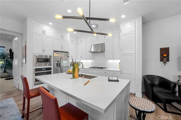 a kitchen with a table chairs and a dining table