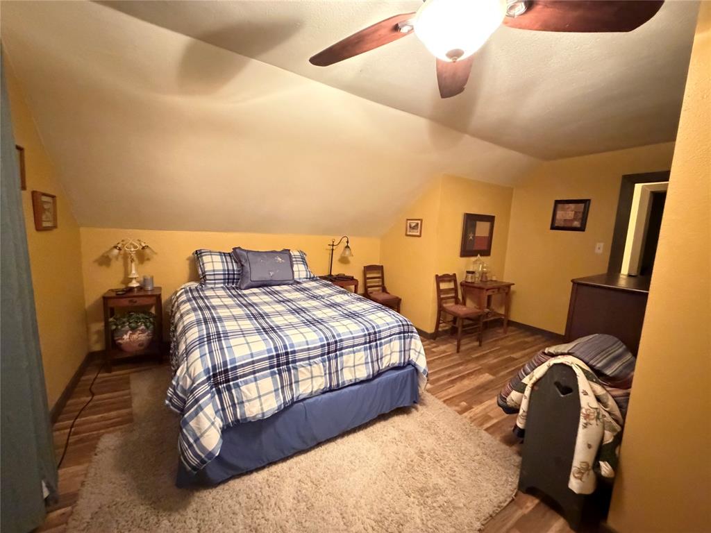 330 South Goode Road Wilmer, TX 75172 - Photo 29 of 38 a bedroom with a bed and wooden floor