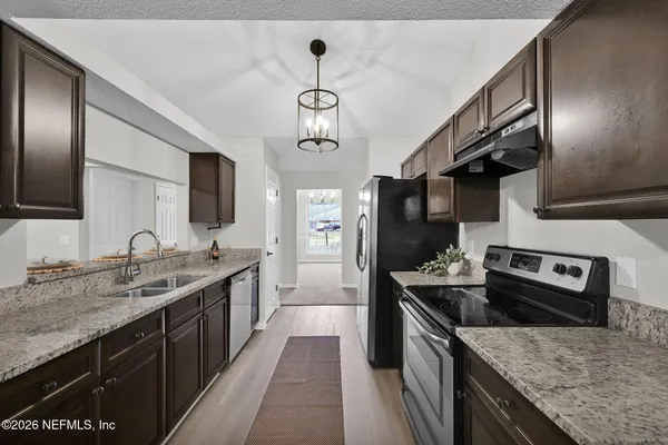 a bedroom with a large bed and a potted plant