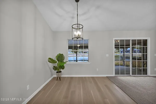 a spacious bedroom with a bed and glass windows