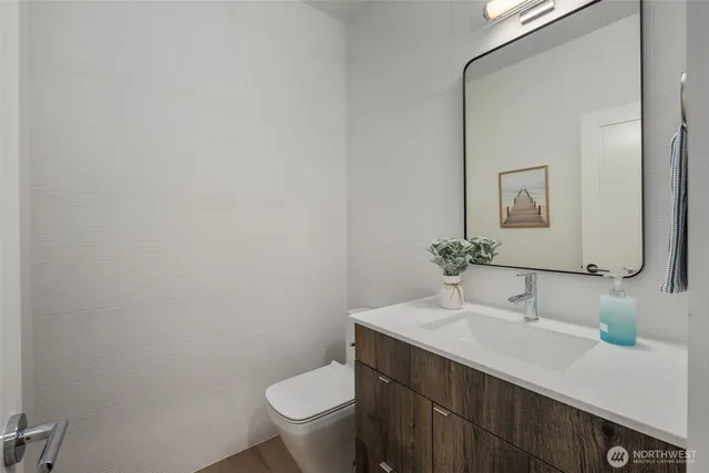 a bedroom with a large bed and a potted plant