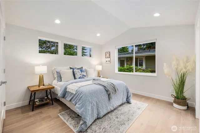 a bedroom with a bed and a white wall