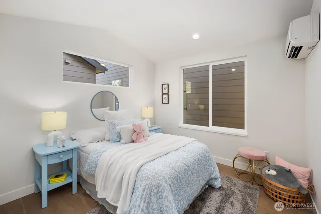 a bathroom with a granite countertop sink a toilet a mirror and shower