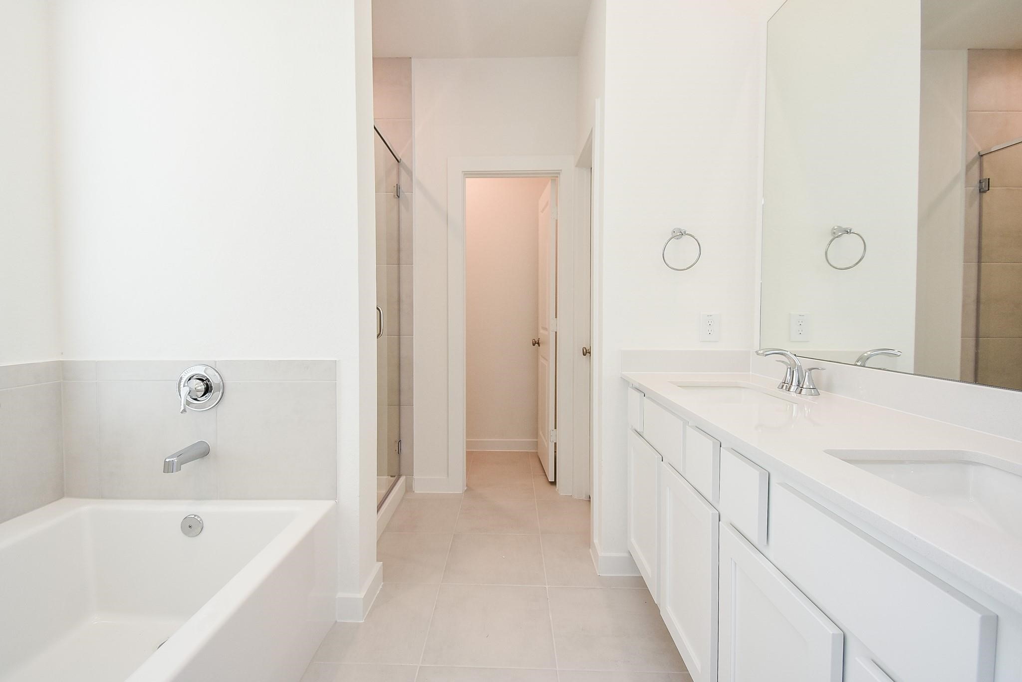 5115 Murillo Drive Manvel, TX 77578 - Photo 16 of 31 a bathroom with a tub sink and mirror