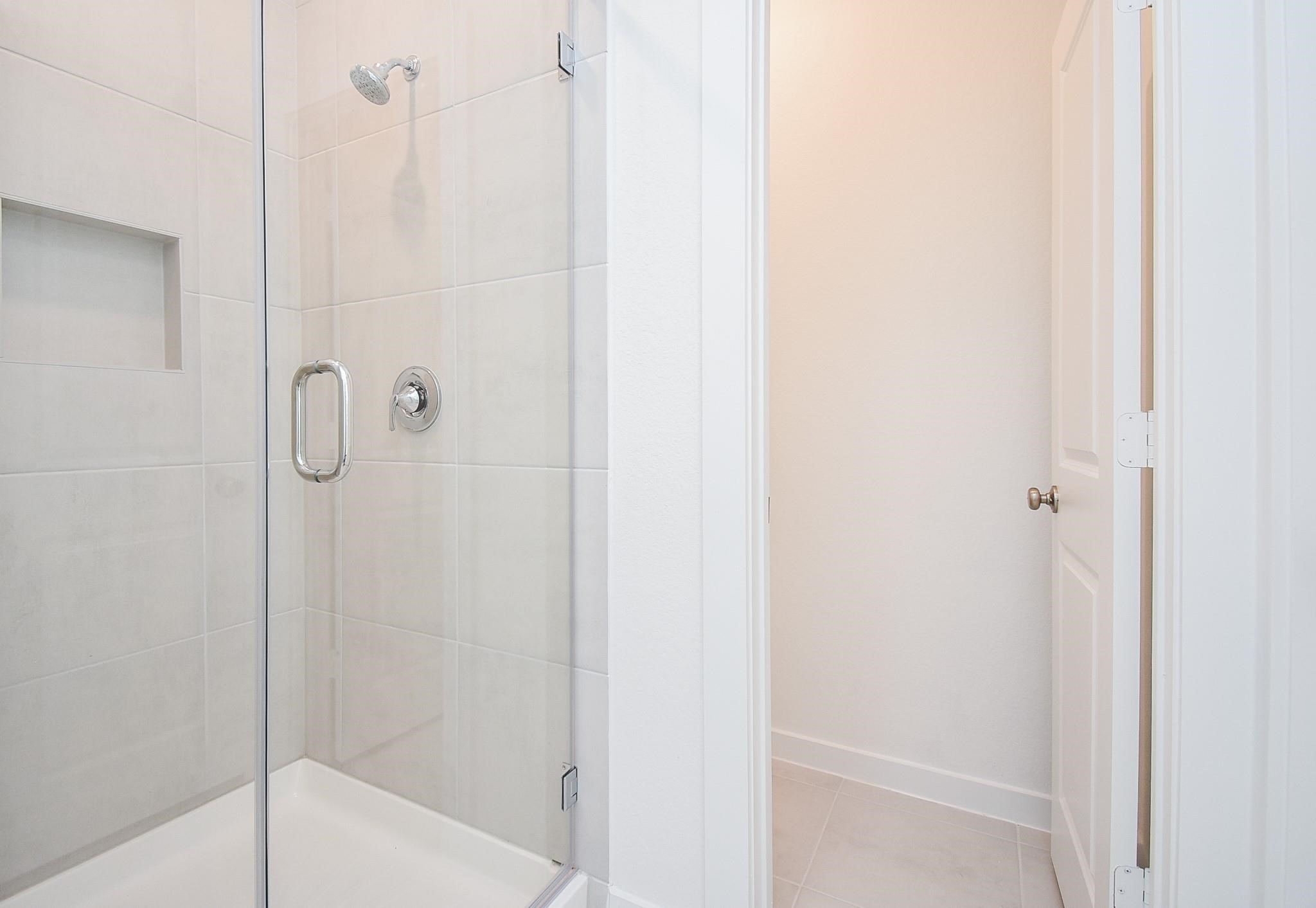 5115 Murillo Drive Manvel, TX 77578 - Photo 17 of 31 a bathroom with a glass shower door