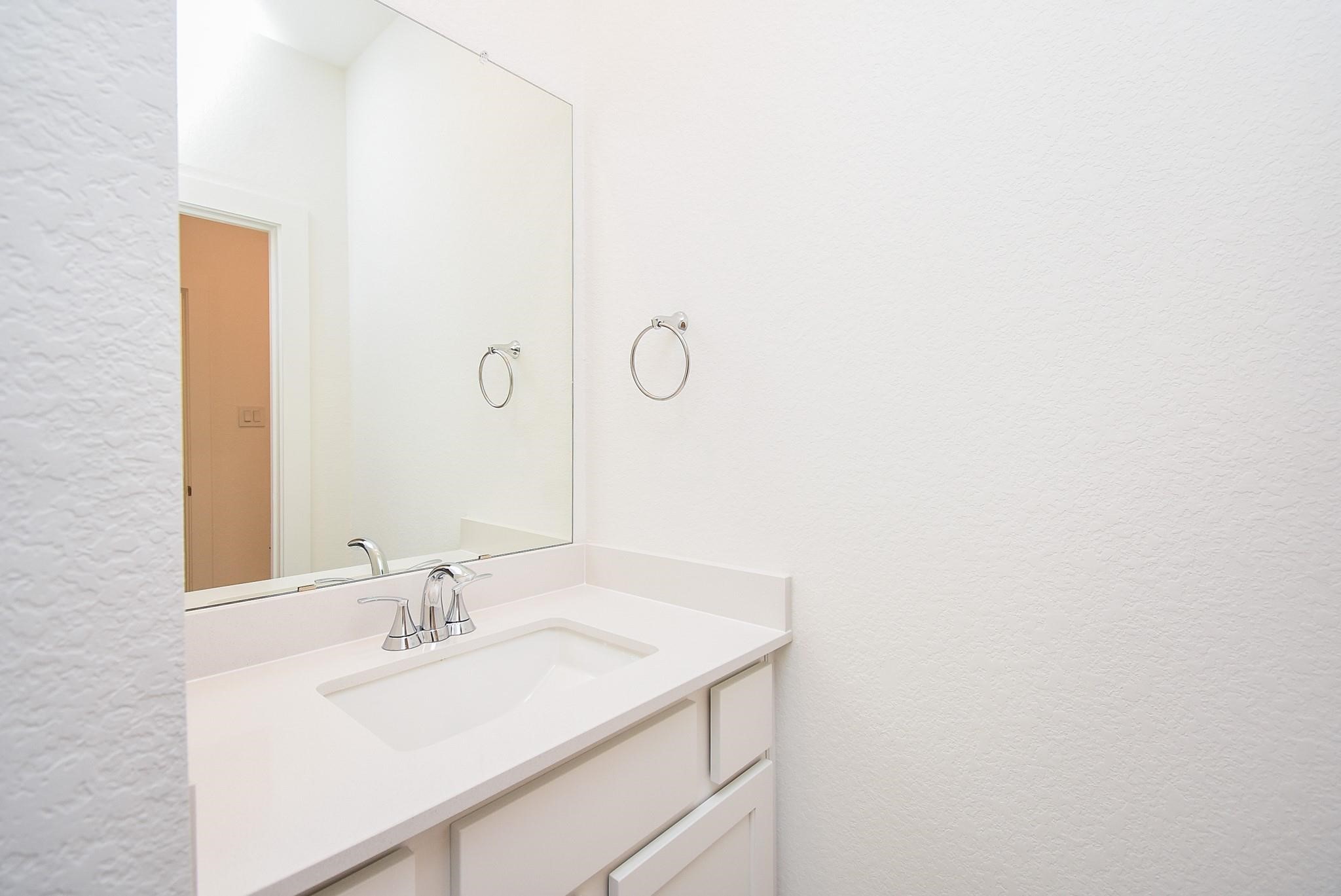 5115 Murillo Drive Manvel, TX 77578 - Photo 22 of 31 a bathroom with a sink and a mirror