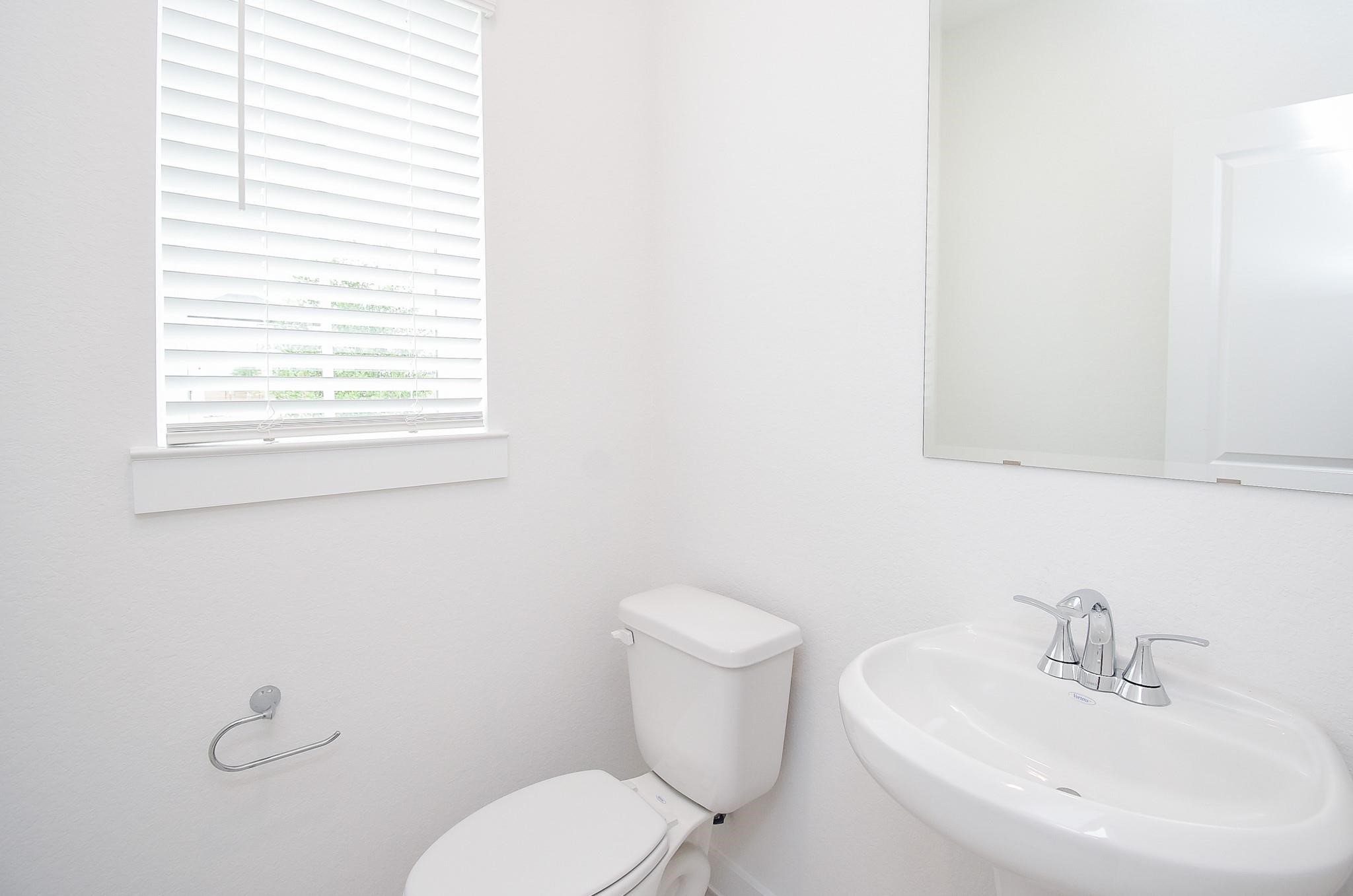 5115 Murillo Drive Manvel, TX 77578 - Photo 23 of 31 a bathroom with a sink a toilet and a mirror
