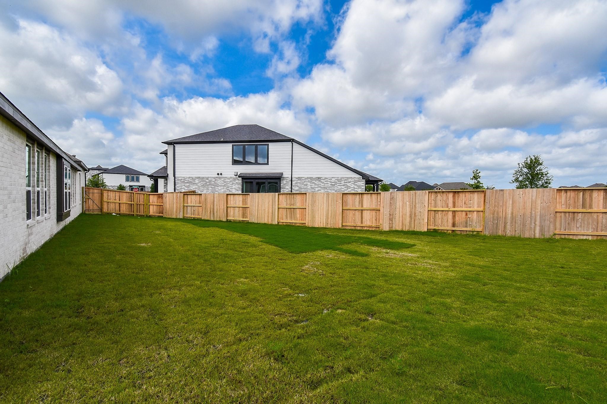 5115 Murillo Drive Manvel, TX 77578 - Photo 28 of 31 a view of a house with a big yard potted plants and large tree