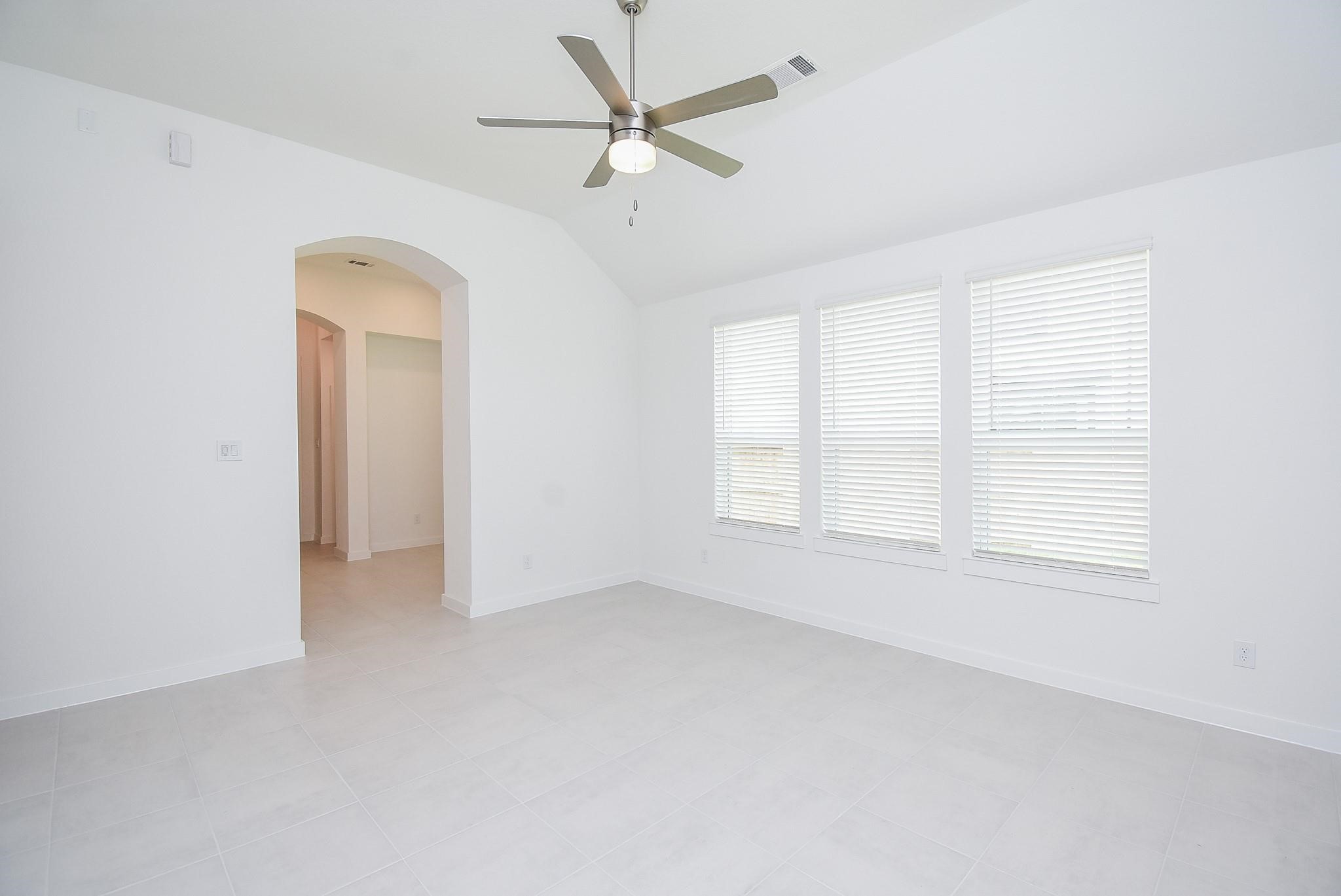 5115 Murillo Drive Manvel, TX 77578 - Photo 8 of 31 an empty room with chandelier fan and windows