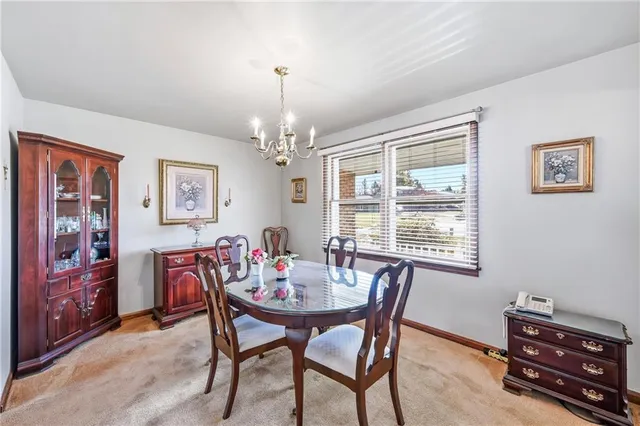 a view of a dining room with furniture and chandelier