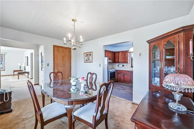 a view of a dining room with furniture and chandelier