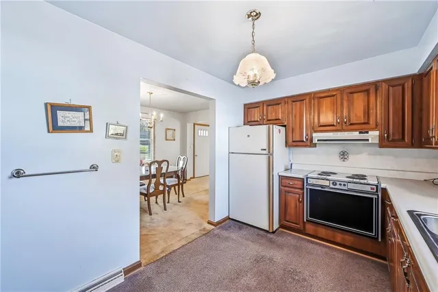a view of a kitchen with a sink stove and refrigerator