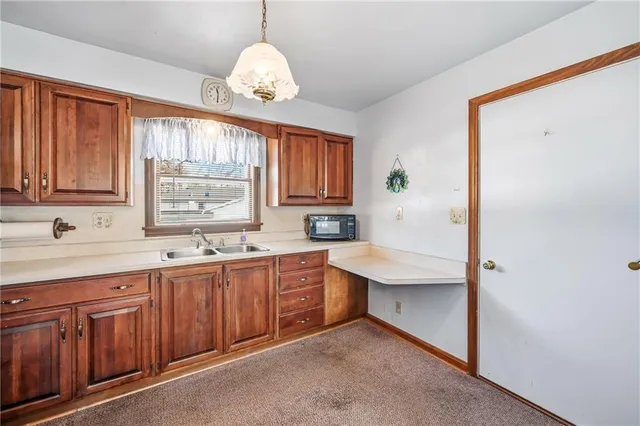 a spacious bathroom with a sink a mirror and a large window
