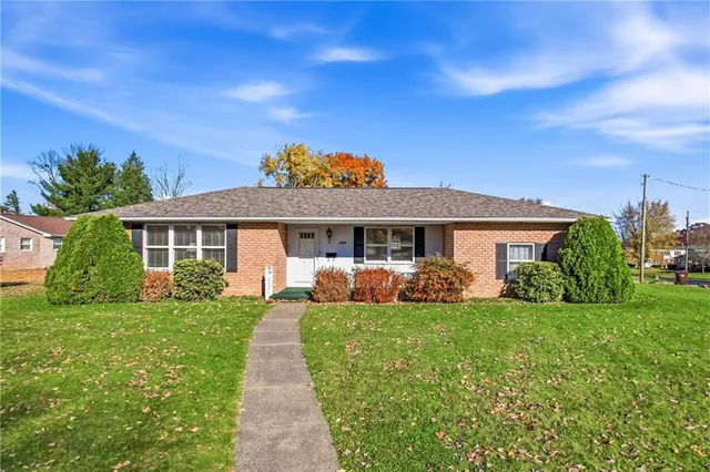 a front view of a house with a yard