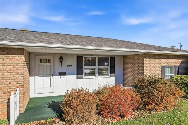 front view of a house with a large window